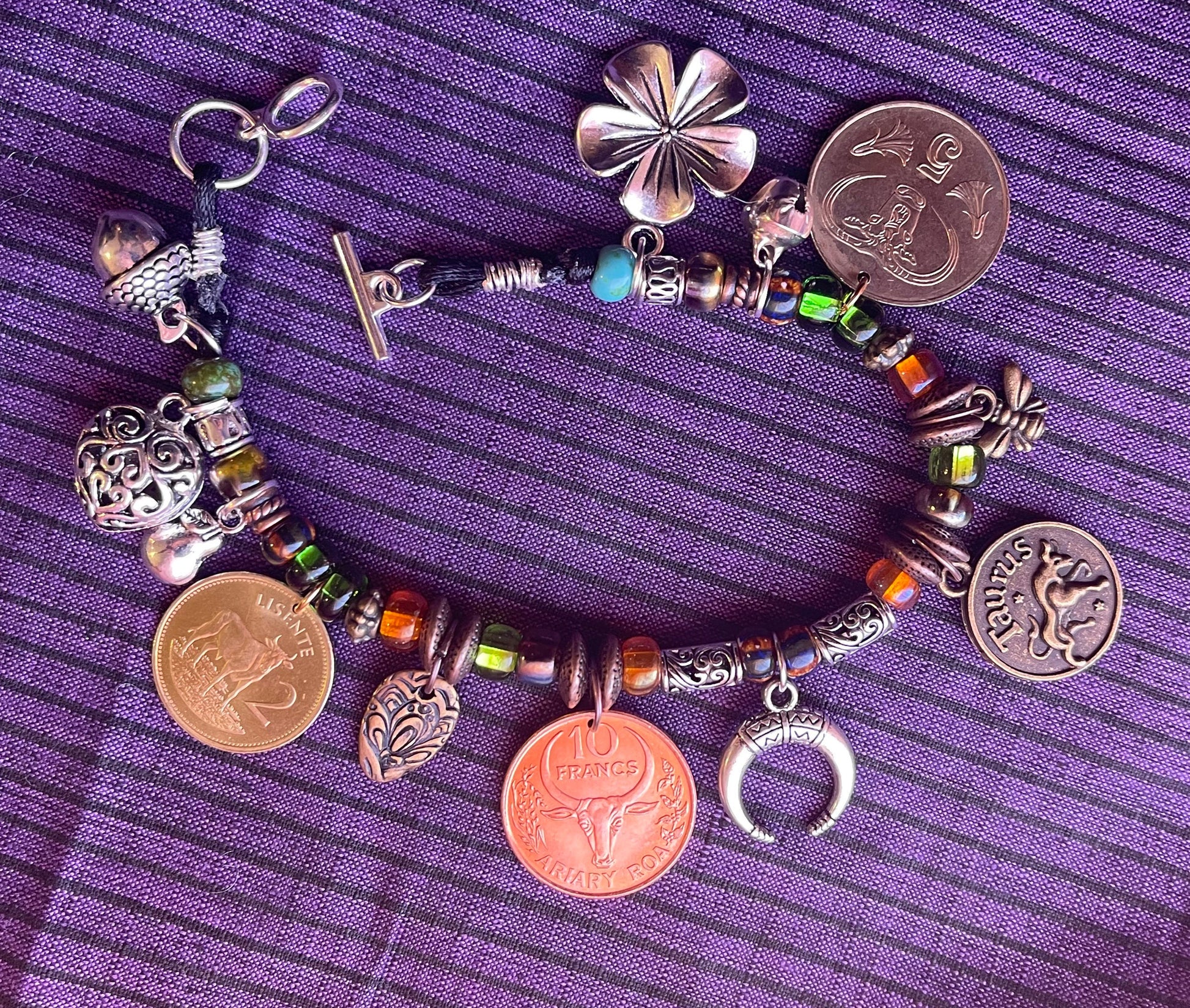 Taurus/Ferdinand the Bull genuine world coin jingle charm bracelet (flower–bell–tinkly heart–bee–moon) Czech glass, silver toggle (zodiac)