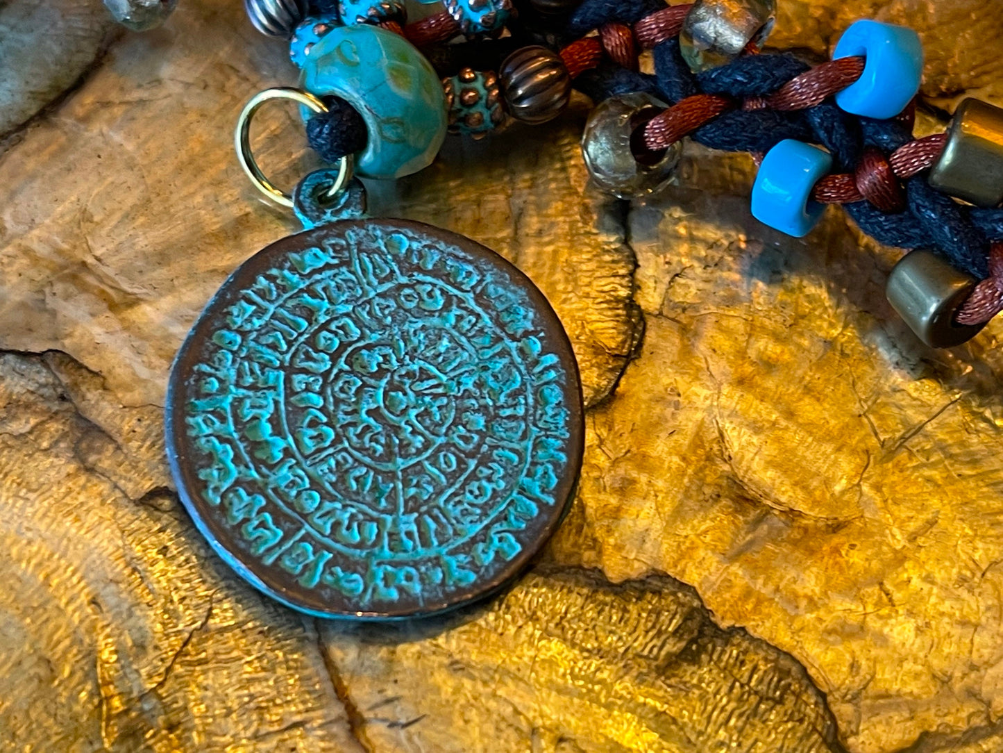 Phaistos Disk necklace–Greek Bronze pendant w Green Patina–fire polished Czech crystal–adjustable button closure–fine archaeological replica