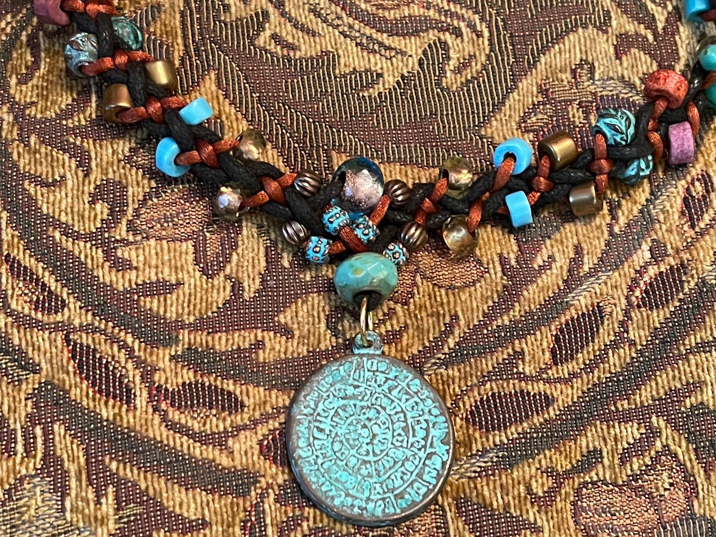 Phaistos Disk necklace–Greek Bronze pendant w Green Patina–fire polished Czech crystal–adjustable button closure–fine archaeological replica