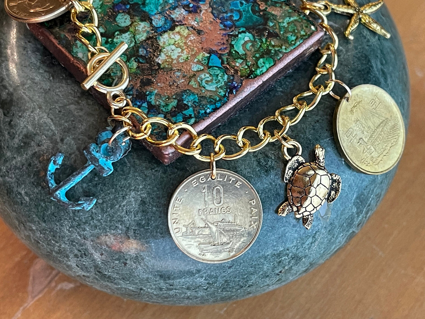 On the High Seas: Gold-plated designer bracelet – ships, starfish, sea turtle, sun, star, nautical–coins, charms– toggle clasp