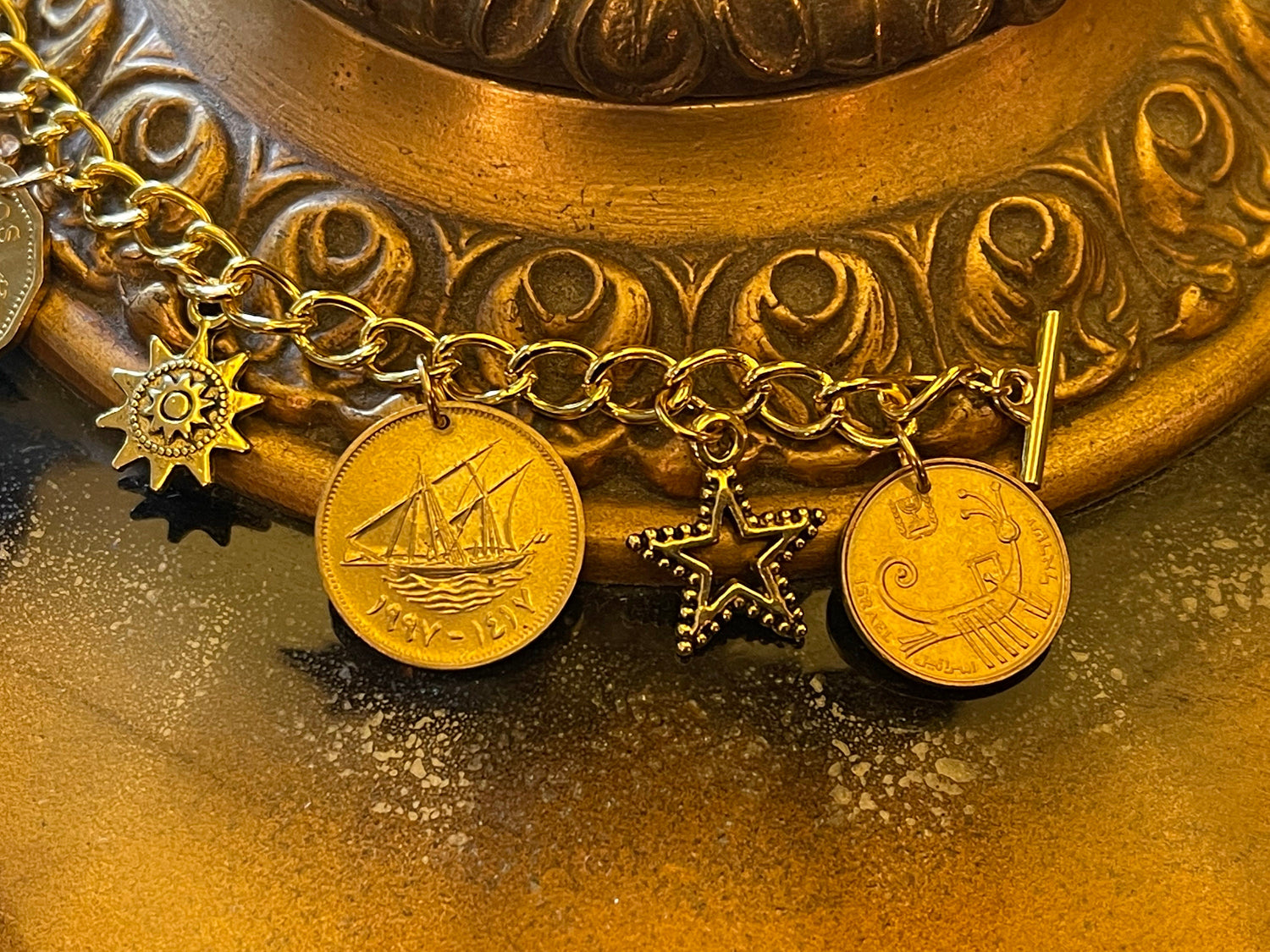 On the High Seas: Gold-plated designer bracelet – ships, starfish, sea turtle, sun, star, nautical–coins, charms– toggle clasp