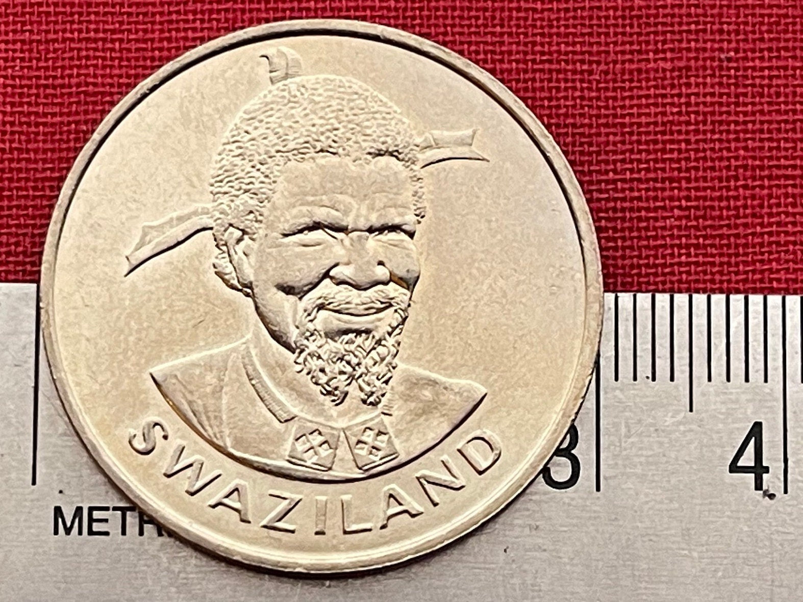 Woman with Beehive Sicolo Hairdo, Husking Corn & King Sobhuza 1 Lilangeni Swaziland Authentic Coin Money for Jewelry (1981) (Eswatini) Maize